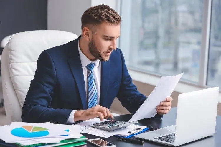 Can the ATO Audit You After 7 Years? 27 accountant sitting at a desk with a laptop and calculator 1 Pinnacle Accounting & Advisory