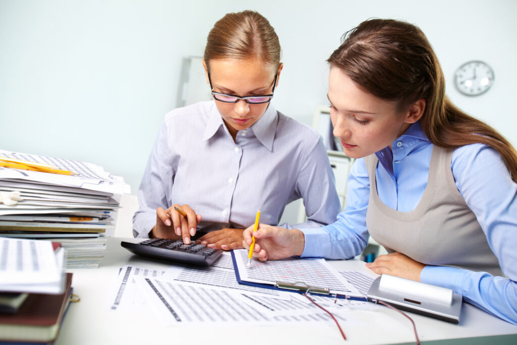 businesswomen reviewing results Pinnacle Accounting & Advisory