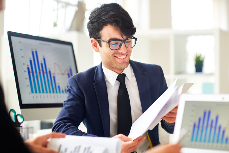 man with papers Pinnacle Accounting & Advisory